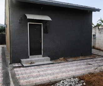 Finished exterior with entrance canopy and paving